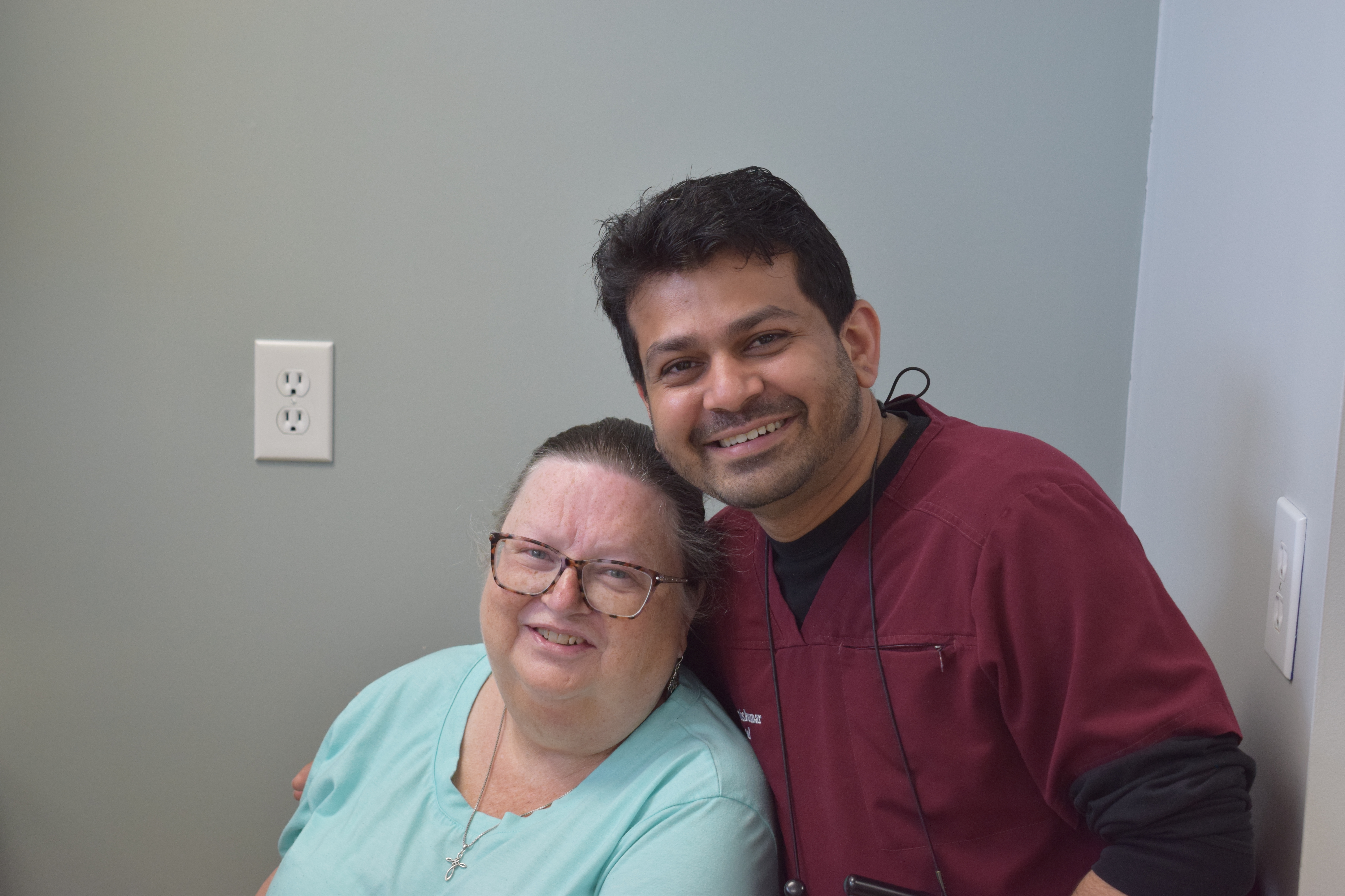 Dr. Jimiskumar Patel with a patient at Patel Dental and Implants